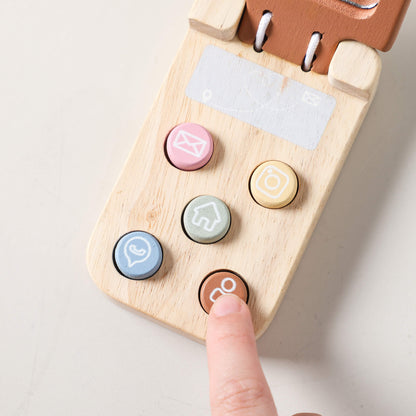 Dettaglio dei tasti colorati su telefono di legno, utili per sviluppare la motricità fine nei giochi in legno educativi.